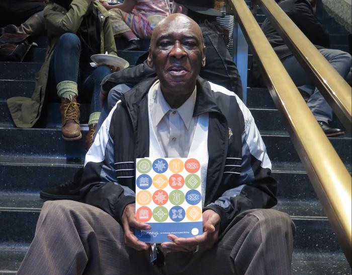 Journeys author holds book