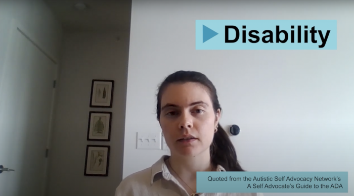 Still from the video with a person sitting in front of a neutral background and a text banner reading "Disability: Quoted from ASAN's A Self Advocate's Guide to the ADA"."