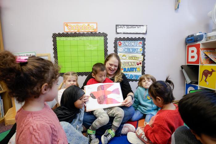 Preschool Teacher Rachel reads to Open Door Preschool students.