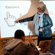 Facilitator teaches a computer class