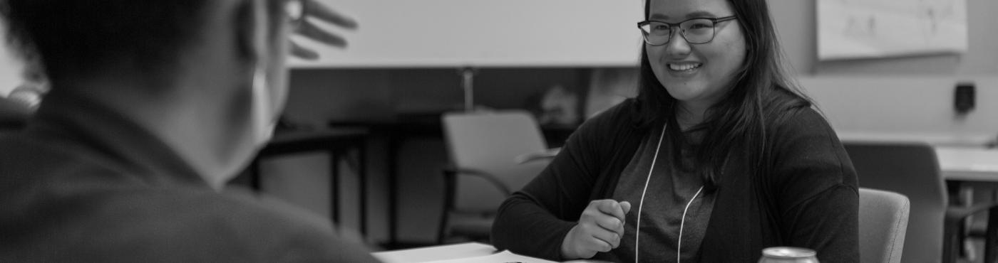 Two AmeriCorps members laugh and converse. 