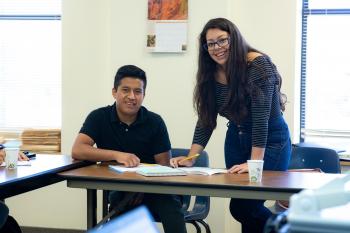 Adult ESL learner and teacher smiling