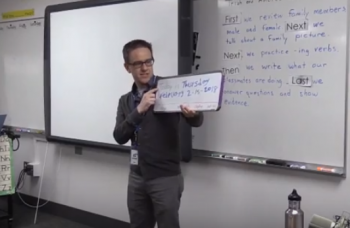 Teacher holding a small whiteboard