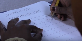 close up of a hand writing on a paper