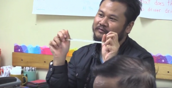 Smiling man stretching a rubber band