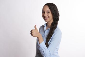 smiling woman giving a thumbs up