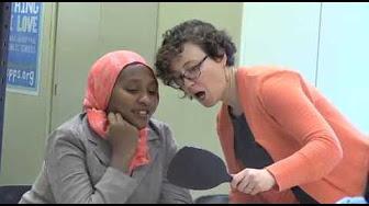 teacher and learner looking into a handheld mirror