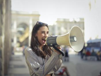 Person yelling into a megaphone (photo from pexels-andrea-piacquadio-3761509)
