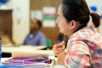 English language learner sitting at a table 