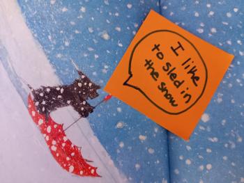 illustration of a dog sledding in an umbrella with a post-it note reading I like to sled in the snow above 