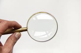 hand holding a magnifying glass