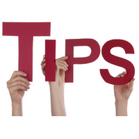Hands holding up letters to spell the word tips in capital letters