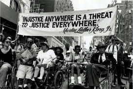 A demonstration for disability rights. Many of the demonstrators are in a wheelchair.