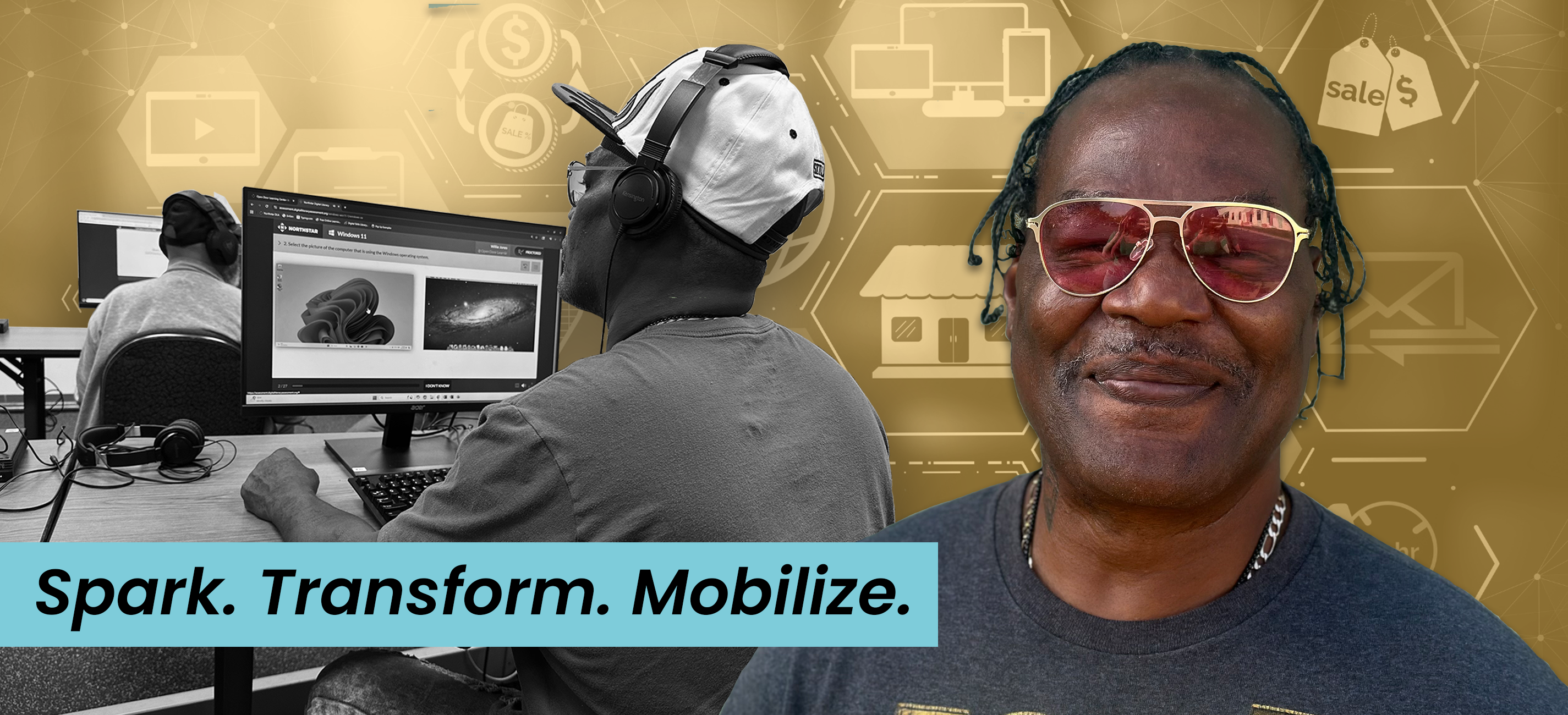 Willie Jones smiles at the camera and works on the computer.