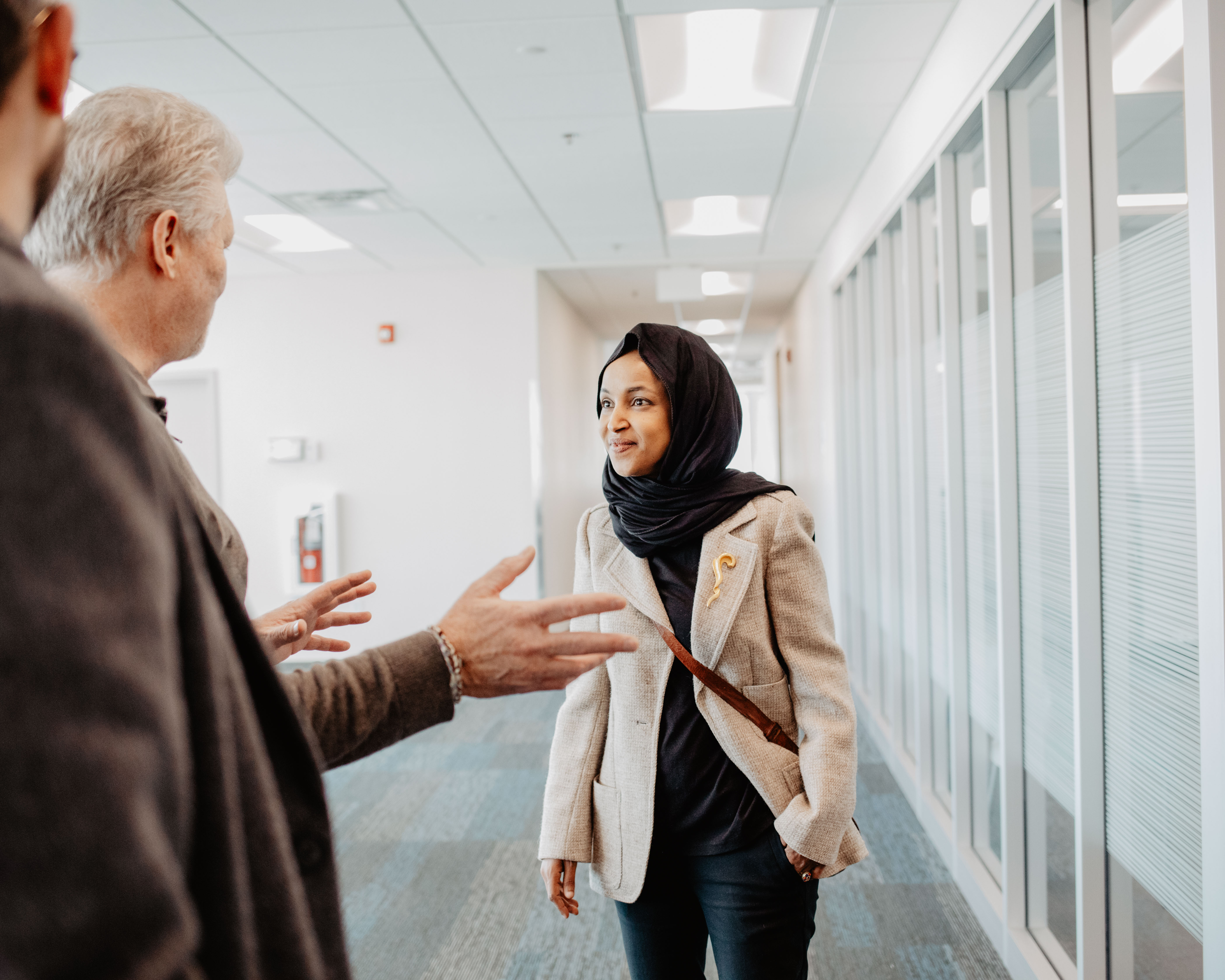 Ilhan Omar tours Open Door Minneapolis campus wearing a black hijab and a tan blazer